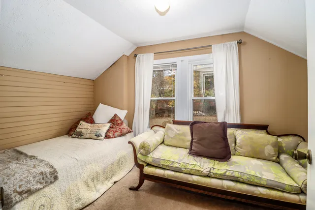 a bedroom with a bed and window