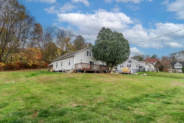 a front view of house with yard and trees