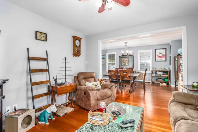 a living room with furniture and wooden floor