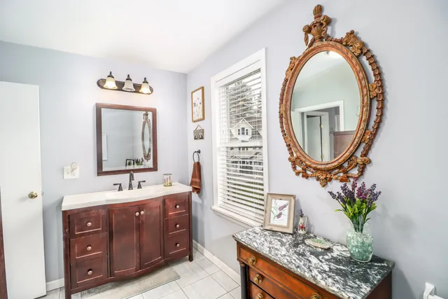 a bathroom with a granite countertop sink mirror and vanity