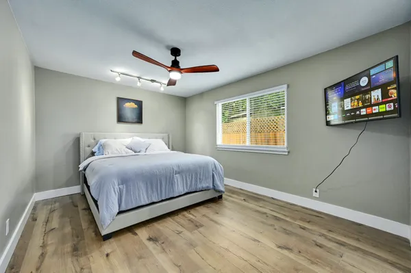 a bedroom with a large bed and a large window