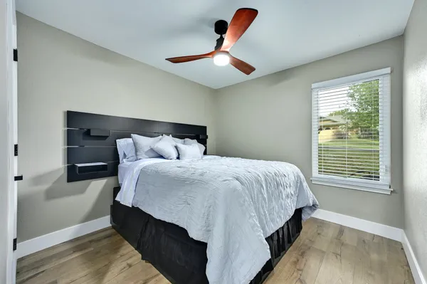 a bedroom with a bed and a window