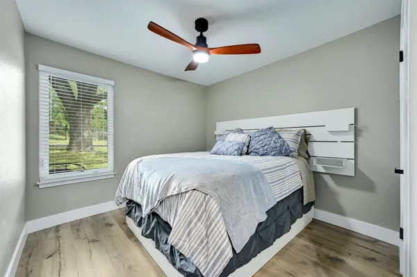 a bedroom with a bed and window