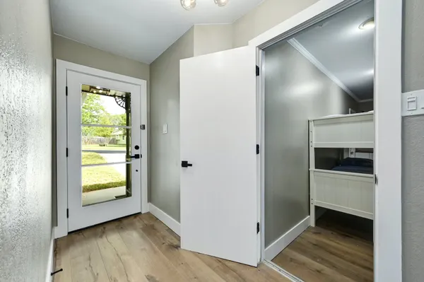 a view of an empty room with a fireplace and a window