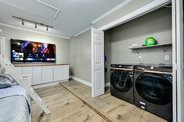 a view of a living room with washer and dryer