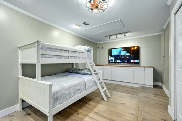 a bedroom with bed and a flat screen tv