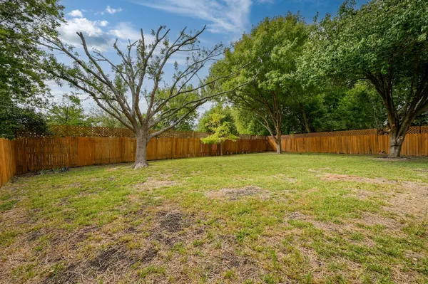 a front view of a house with yard and green space