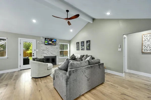 a living room with furniture and a wooden floor