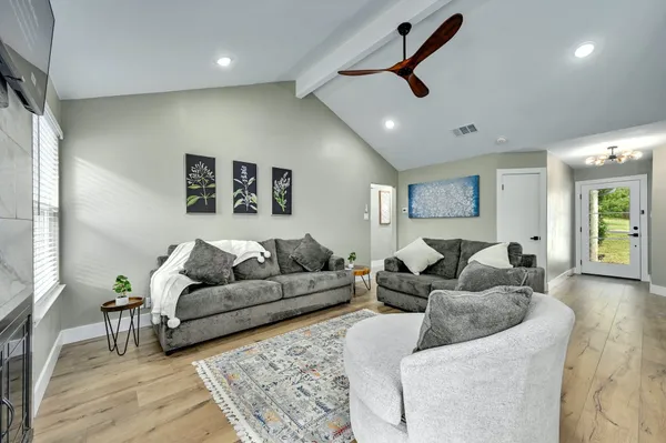 a living room with furniture and a ceiling fan