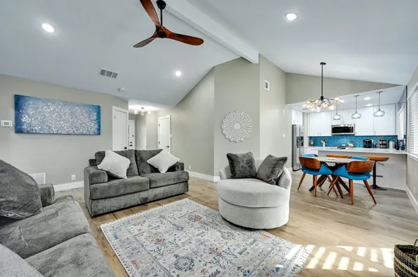 a living room with furniture and a chandelier