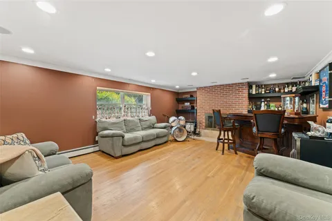 a living room with furniture and view of kitchen