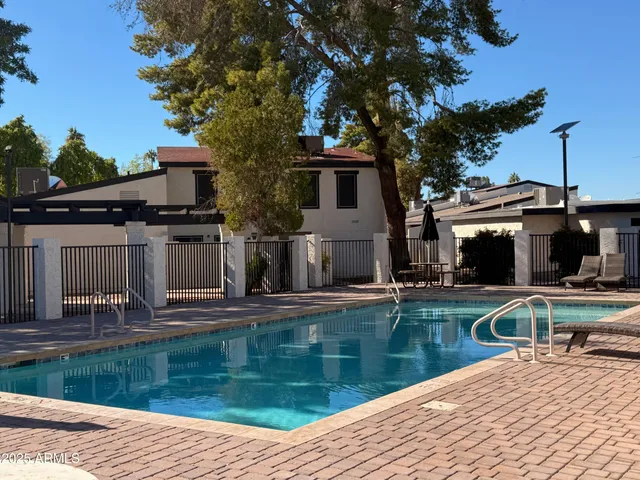 a view of a house with pool and sitting area