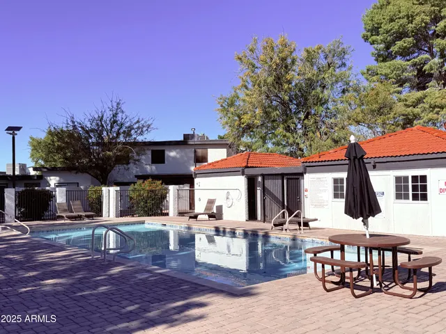 a view of a dinning table and chairs in patio of a house