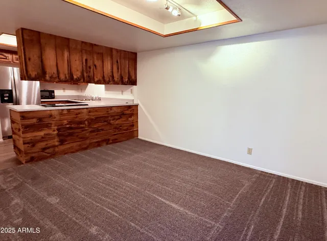 a room with granite countertop cabinets and a wooden floor