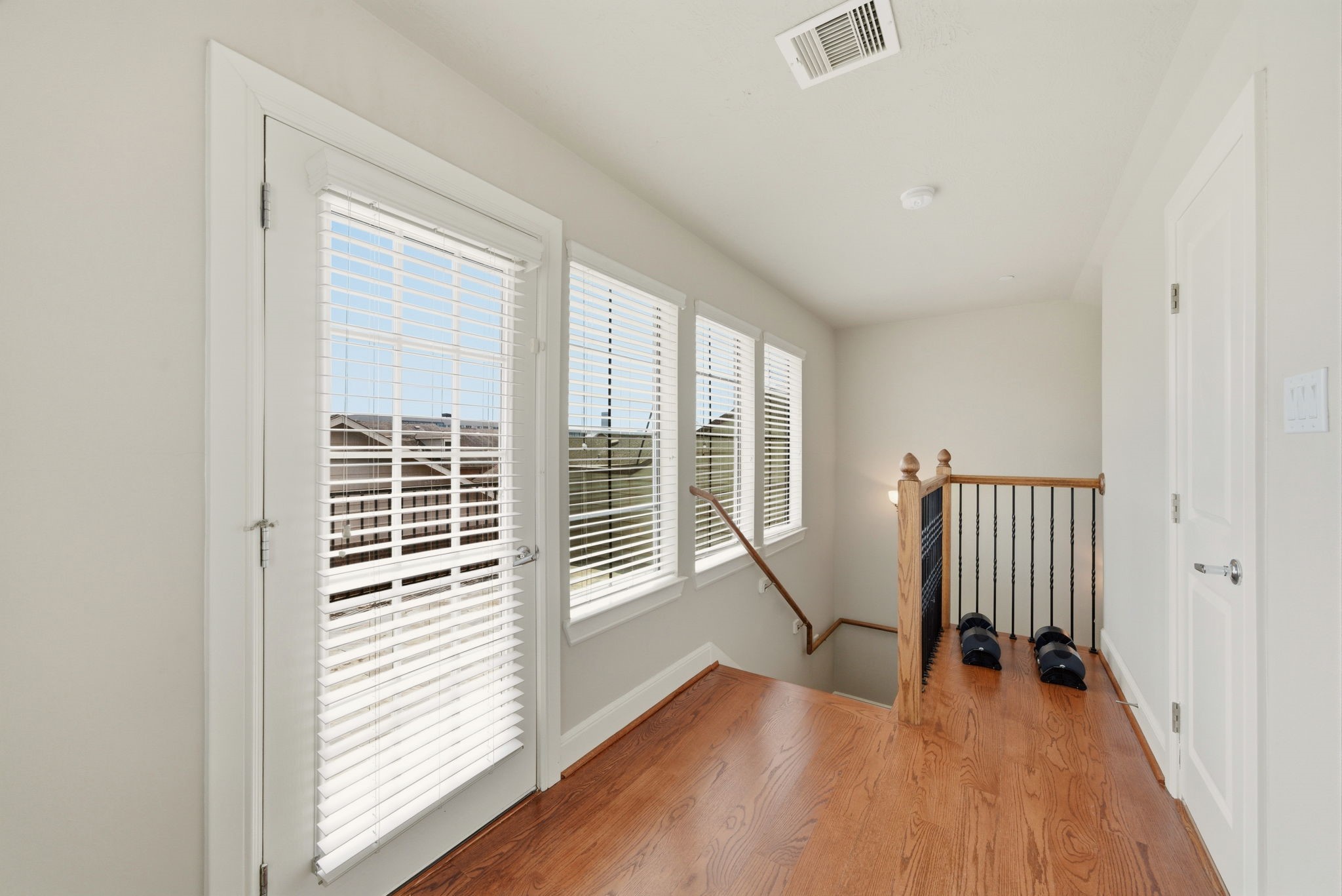 2110 Shearn Street, Unit 16 Houston, TX 77007 - Photo 23 of 37 Up to the 4th floor! Plenty of windows! Small area for a desk. Or have a mini fridge up here - easy access to drinks / snacks when on the rooftop deck! WOOD floors continue up here, installed in 2024!