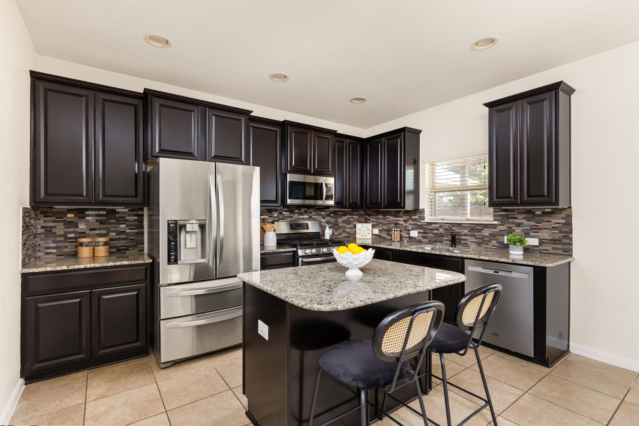 2400 Leonards Pass Leander, TX 78641 - Photo 16 of 40 Culinary delights await in this modern kitchen, featuring an island for gathering and ample cabinetry.