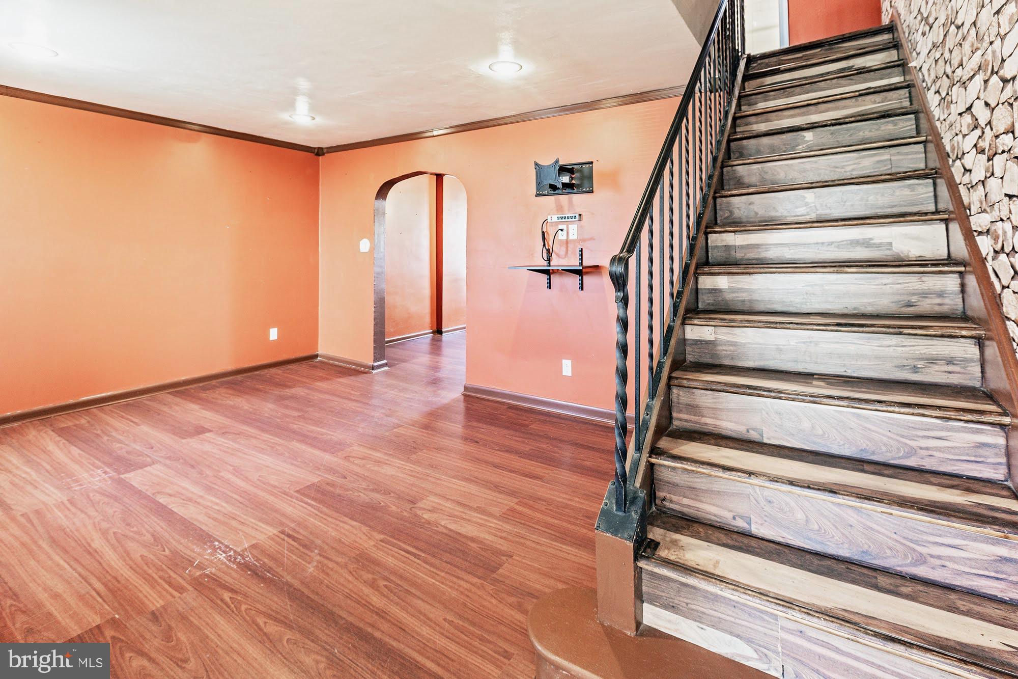 3312 West 13th Street Chester, PA 19013 - Photo 3 of 13 a view of entryway with wooden floor and stairs