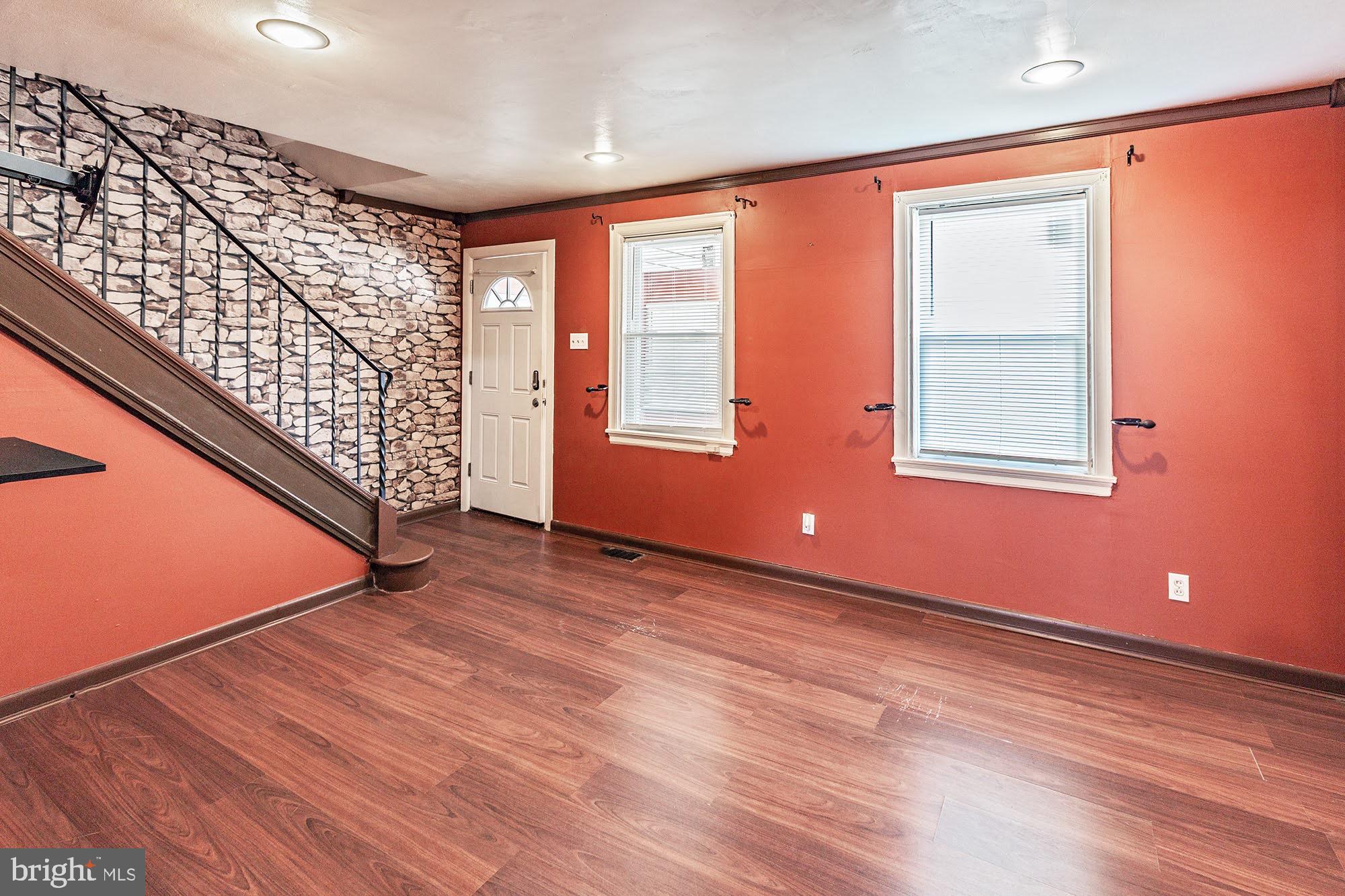 3312 West 13th Street Chester, PA 19013 - Photo 4 of 13 a view of an empty room with wooden floor and a window