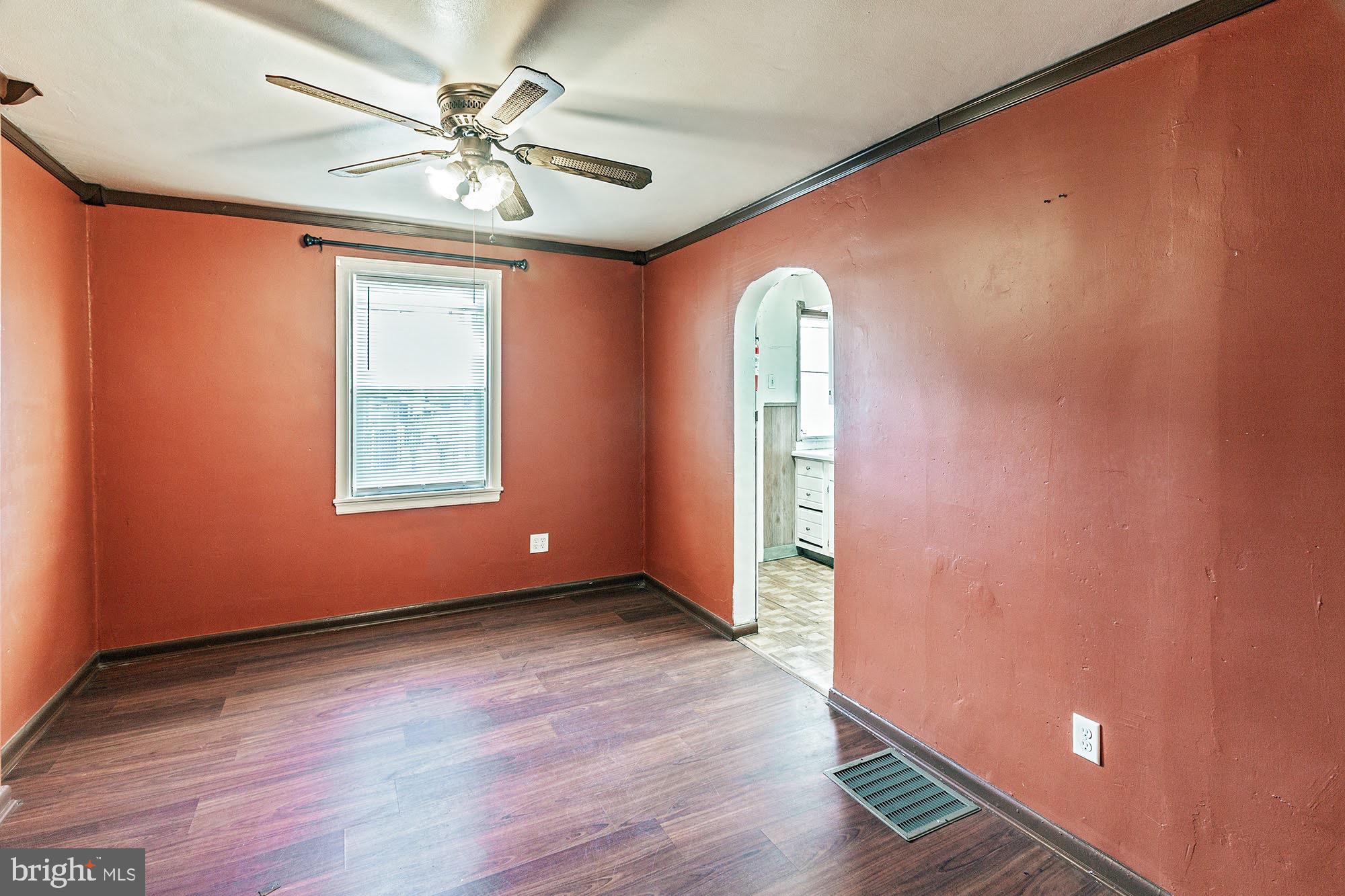 3312 West 13th Street Chester, PA 19013 - Photo 5 of 13 an empty room with windows and fan