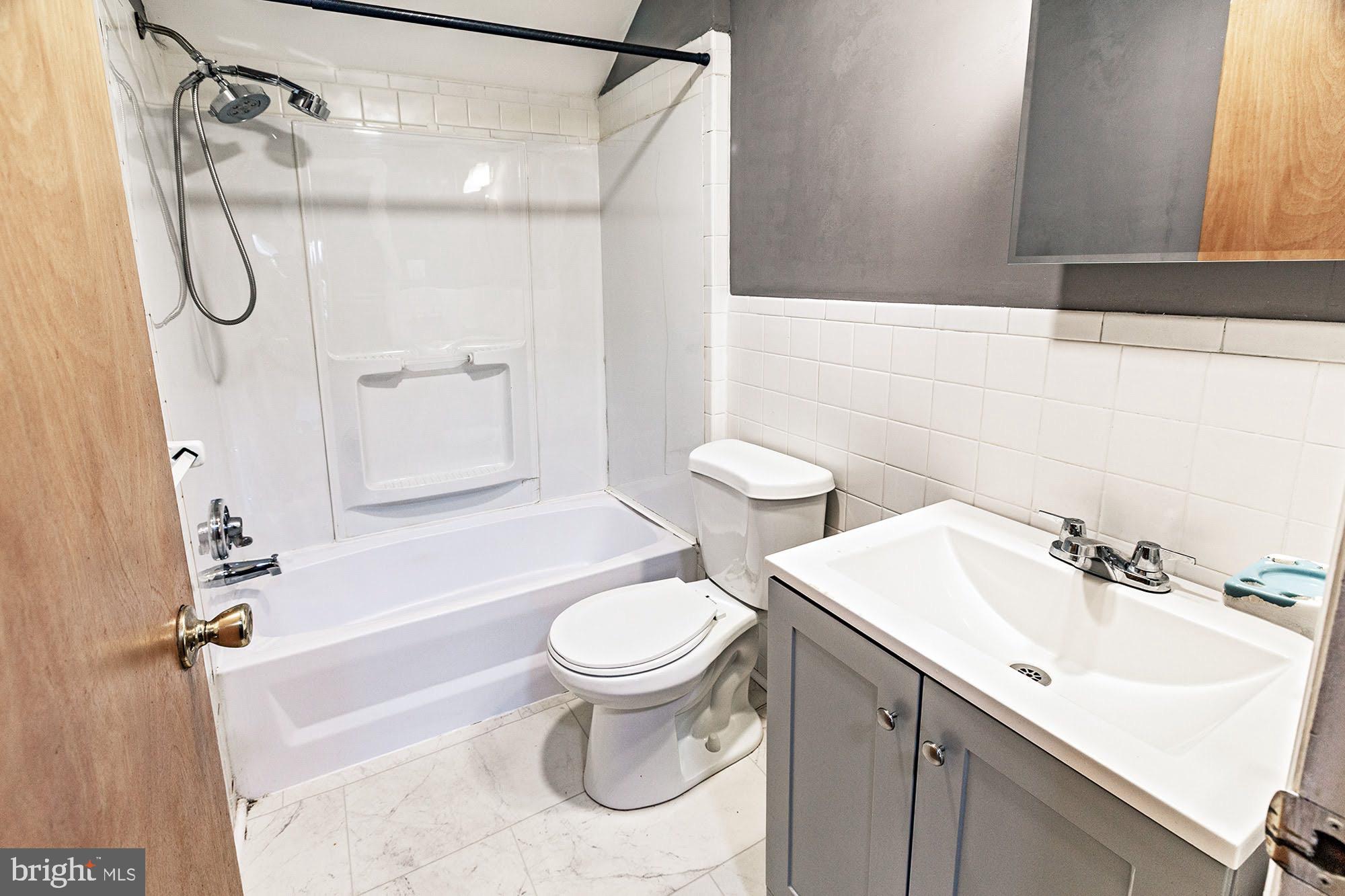 3312 West 13th Street Chester, PA 19013 - Photo 10 of 13 a bathroom with a sink toilet and shower
