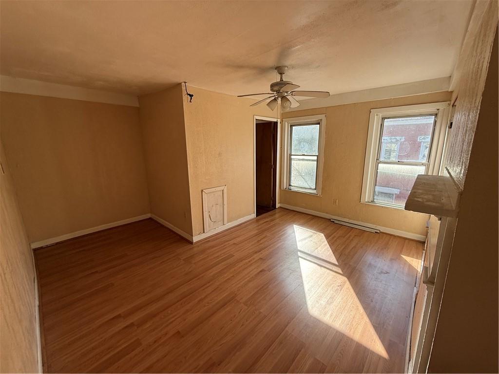 516 Armandale Street Pittsburgh, PA 15212 - Photo 14 of 17 a view of empty room with wooden floor and fan
