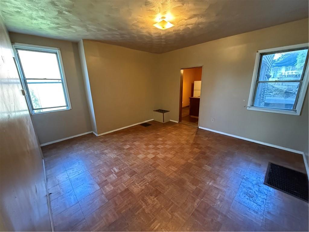 516 Armandale Street Pittsburgh, PA 15212 - Photo 5 of 17 an empty room with wooden floor and windows