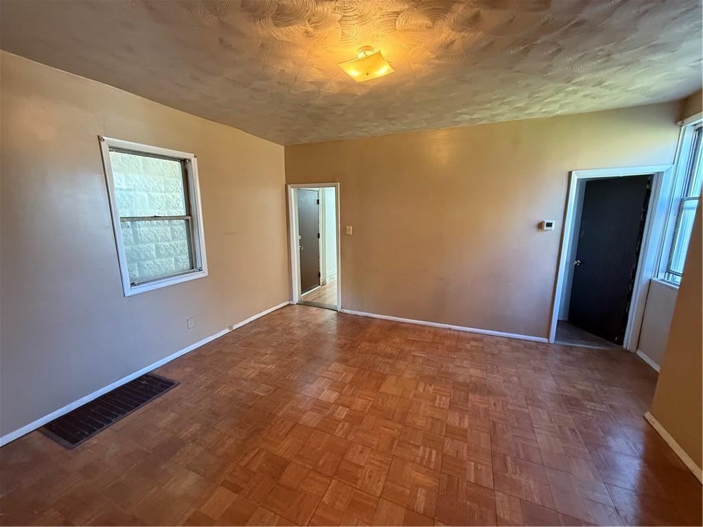 516 Armandale Street Pittsburgh, PA 15212 - Photo 6 of 17 a view of an empty room with wooden floor and a window