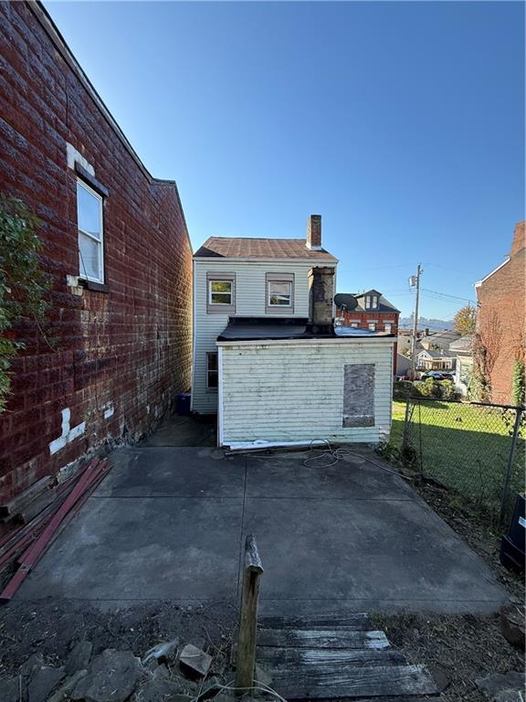 516 Armandale Street Pittsburgh, PA 15212 - Photo 9 of 17 a view of a house with a barbeque and wooden fence
