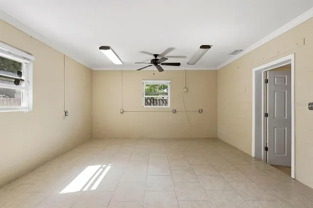 a view of a house with backyard and tree