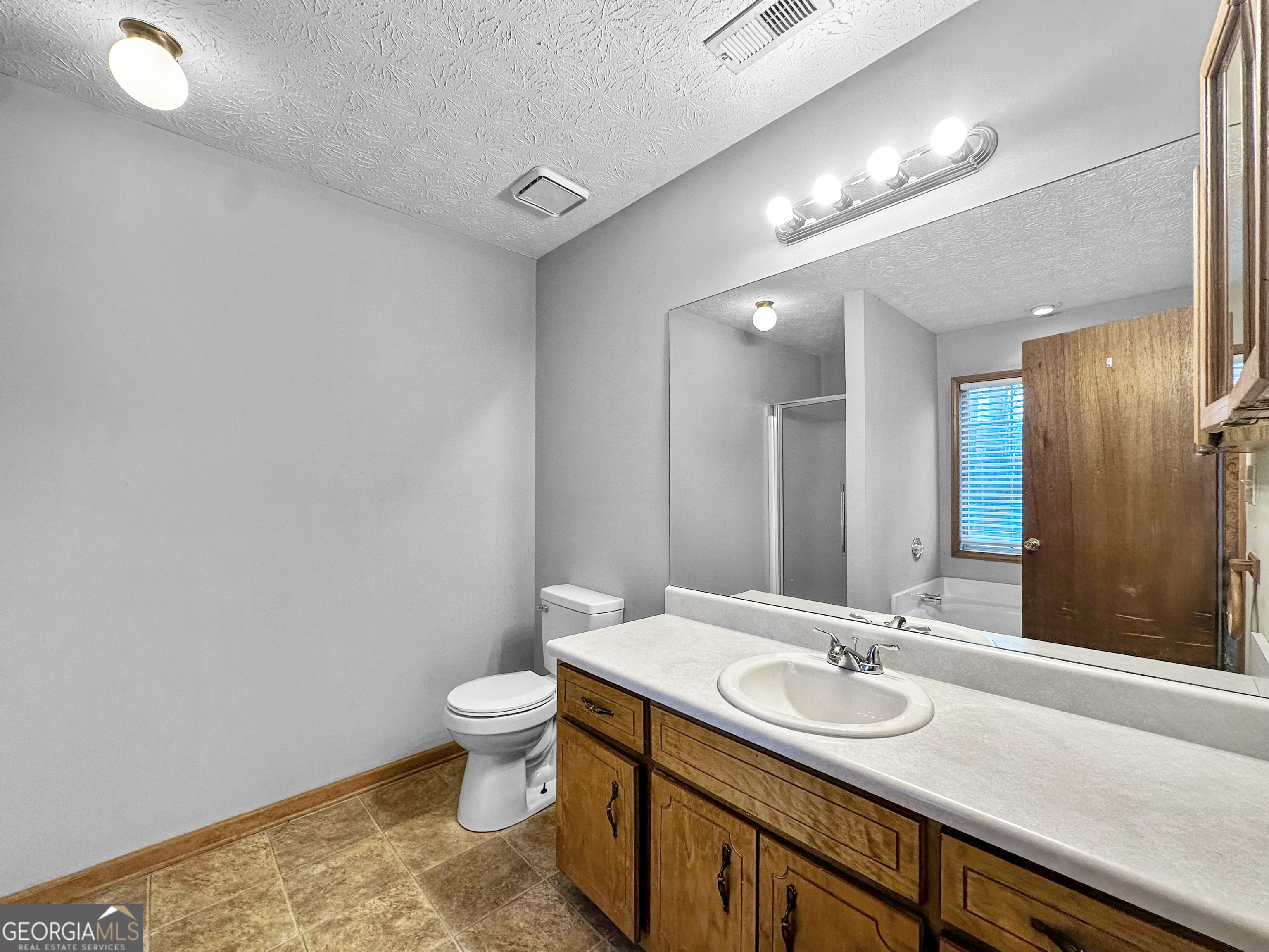 290 Cornwallis Way Fayetteville, GA 30214 - Photo 11 of 18 a bathroom with a sink and a mirror