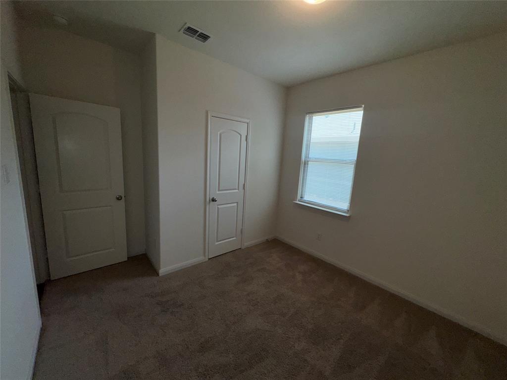 14360 Riata Lane Dallas, TX 75253 - Photo 13 of 16 Carpeted flooring, white interior doors, and a window with a white frame