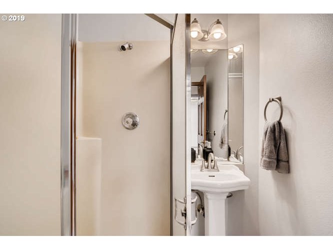 13848 Southwest Whitmore Road Hillsboro, OR 97123 - Photo 15 of 29 a bathroom with a sink vanity and a mirror