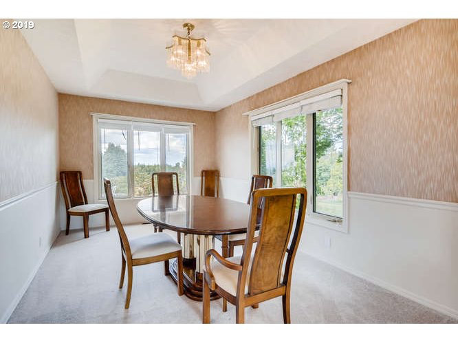 13848 Southwest Whitmore Road Hillsboro, OR 97123 - Photo 7 of 29 a dining room with furniture a chandelier and wooden floor