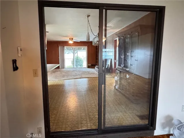 a view of a livingroom with a ceiling fan and window