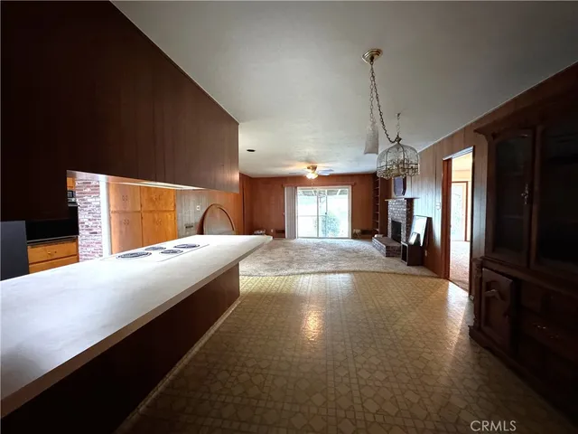 a view of an empty room with closet and a window