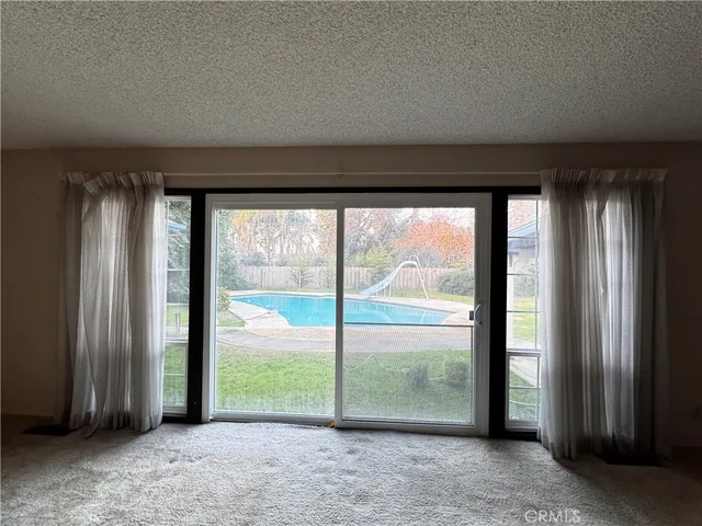a hallway with a white cabinets and wooden floor
