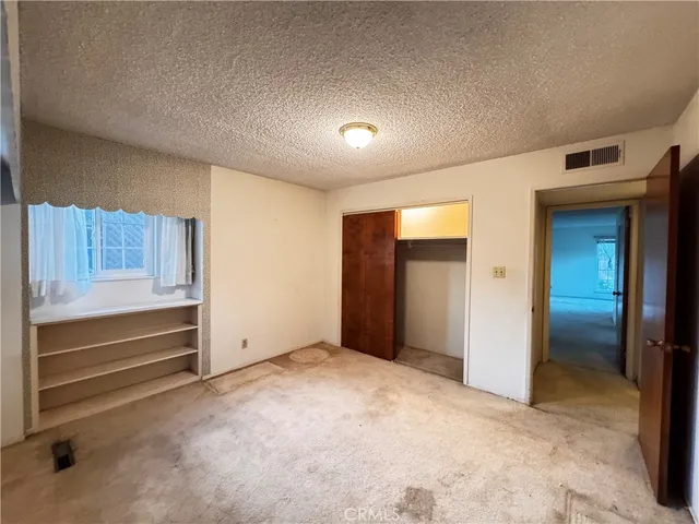 a view of a livingroom with wooden floor and entryway