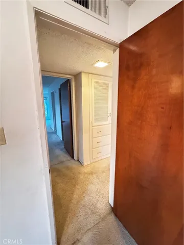 a view of a door and chair under an umbrella