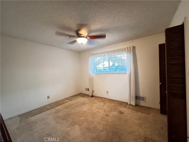 a view of a swimming pool with a yard and plants