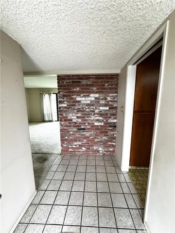 a view of a kitchen with kitchen island a sink stainless steel appliances and cabinets