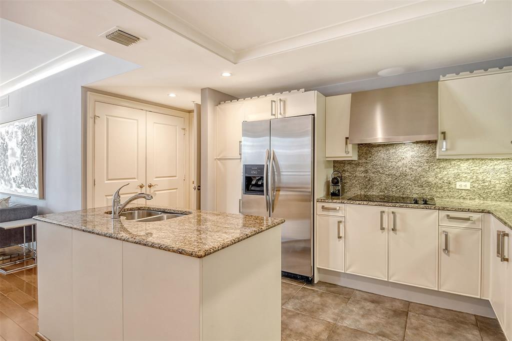 1350 Main Street, Unit 903 Sarasota, FL 34236 - Photo 17 of 71 a kitchen with stainless steel appliances granite countertop a sink and a refrigerator