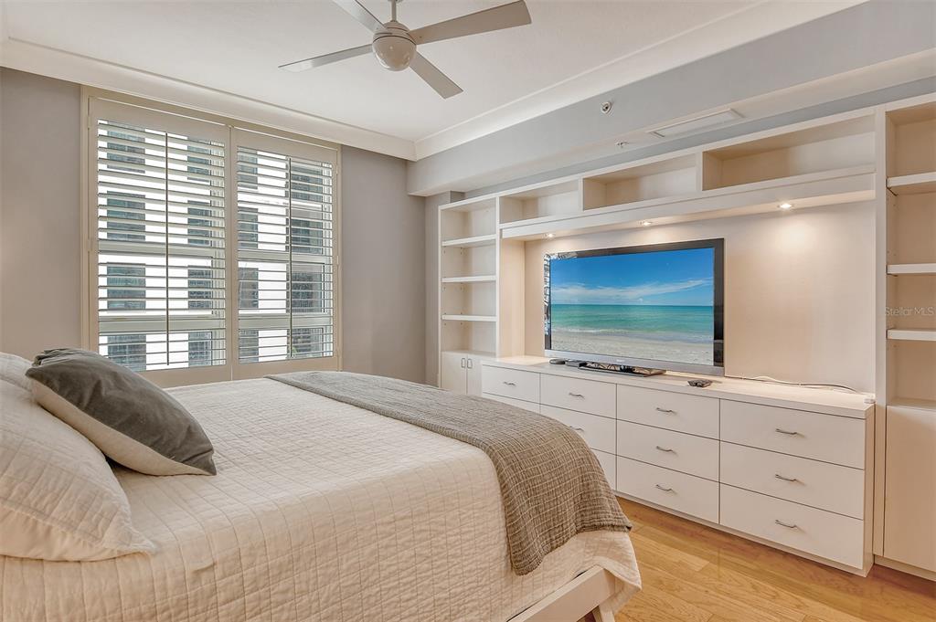 1350 Main Street, Unit 903 Sarasota, FL 34236 - Photo 22 of 71 a bedroom with a large bed and a flat screen tv on the dresser