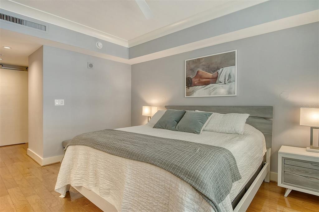 1350 Main Street, Unit 903 Sarasota, FL 34236 - Photo 23 of 71 a bedroom with a bed and a painting on the wall