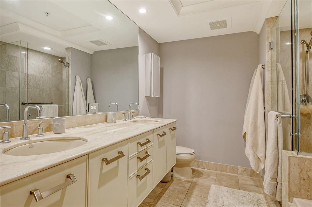 1350 Main Street, Unit 903 Sarasota, FL 34236 - Photo 24 of 71 a bathroom with a granite countertop sink a mirror and a shower