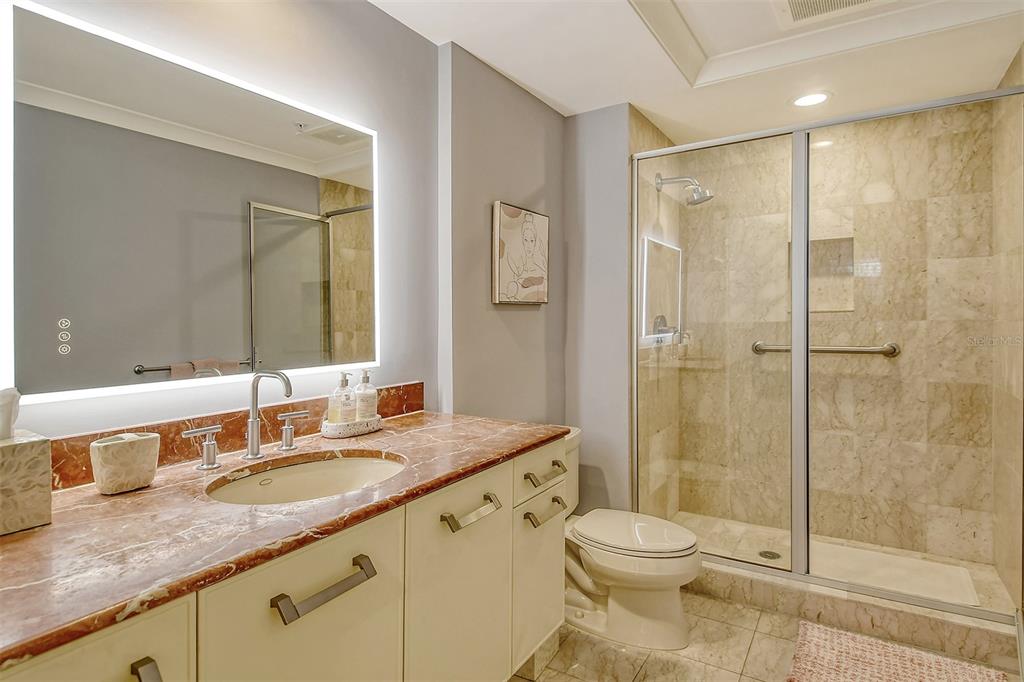 1350 Main Street, Unit 903 Sarasota, FL 34236 - Photo 30 of 71 a bathroom with a granite countertop sink toilet and shower