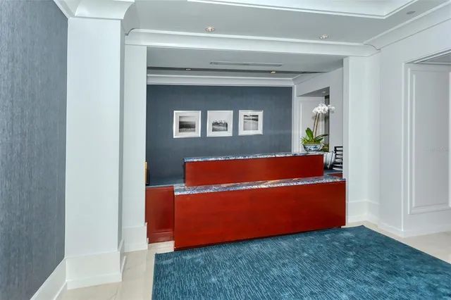 a living room with stainless steel appliances granite countertop a couch a dining table and chairs