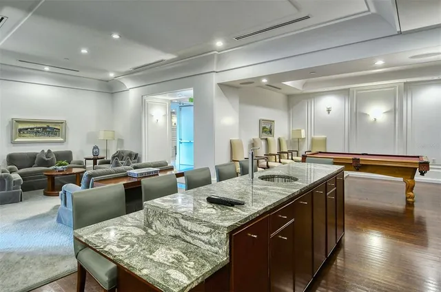 a view of swimming pool with outdoor seating and plants