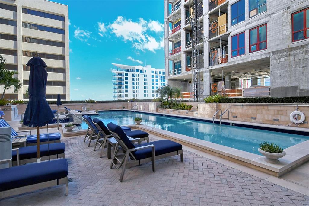 1350 Main Street, Unit 903 Sarasota, FL 34236 - Photo 46 of 71 a swimming pool with outdoor seating and a potted plant