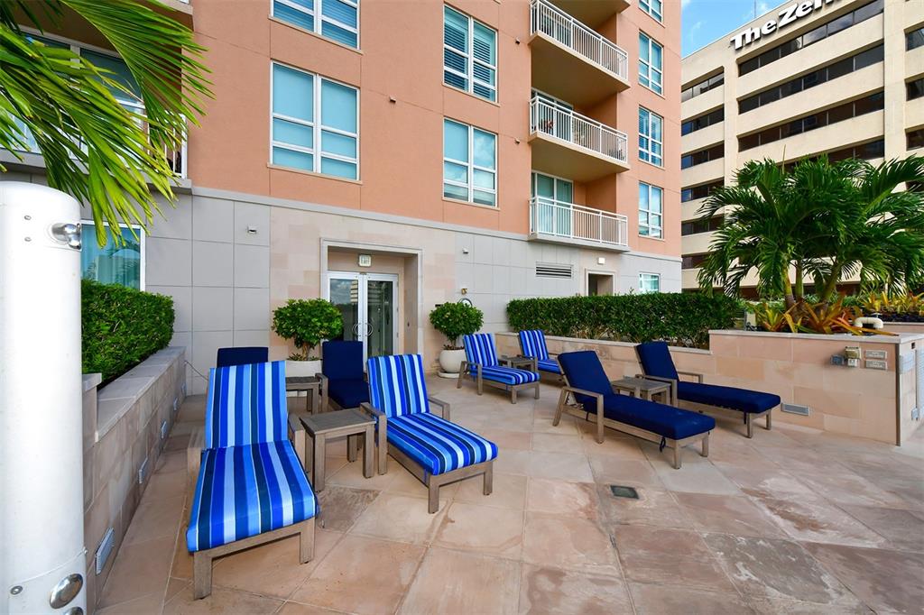 1350 Main Street, Unit 903 Sarasota, FL 34236 - Photo 47 of 71 a view of swimming pool with outdoor seating and plants