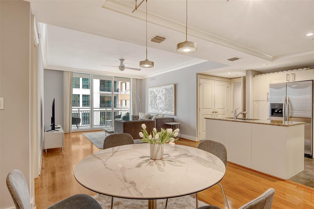 1350 Main Street, Unit 903 Sarasota, FL 34236 - Photo 6 of 71 a dining room with furniture and wooden floor